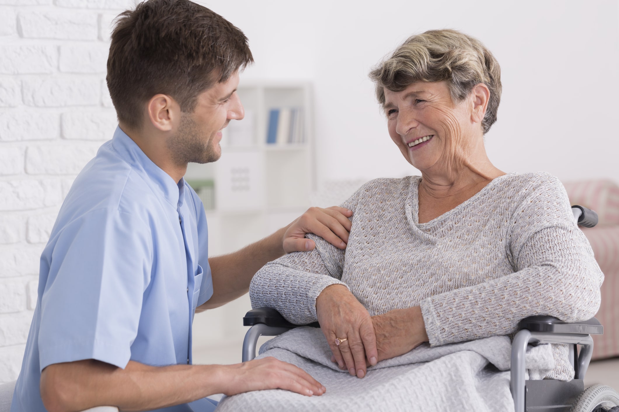 Nurse speaking with a patient in wheelchair